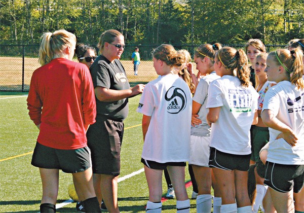 The Overlake School girls’ soccer coach Sally Goodspeed addresses her team during a recent practice. Goodspeed has guided the Owls to two consecutive state finals berths. 'We’re already working really hard