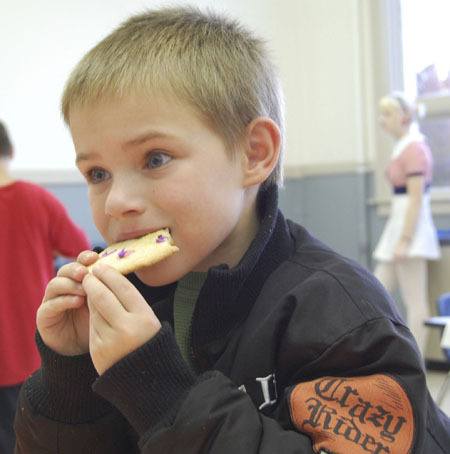 Redmond Elementary School second-grader Hayden Wayne enjoys his decorated Halloween cookie at an after-school Halloween party last Friday at the Old Redmond Schoolhouse Community Center.