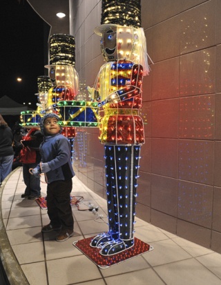 Two-year-old Michael Montero gets a close look at some lit-up Nutcracker-style holiday decorations during the 10th Annual RedmondLights Winter Festival Sunday evening.