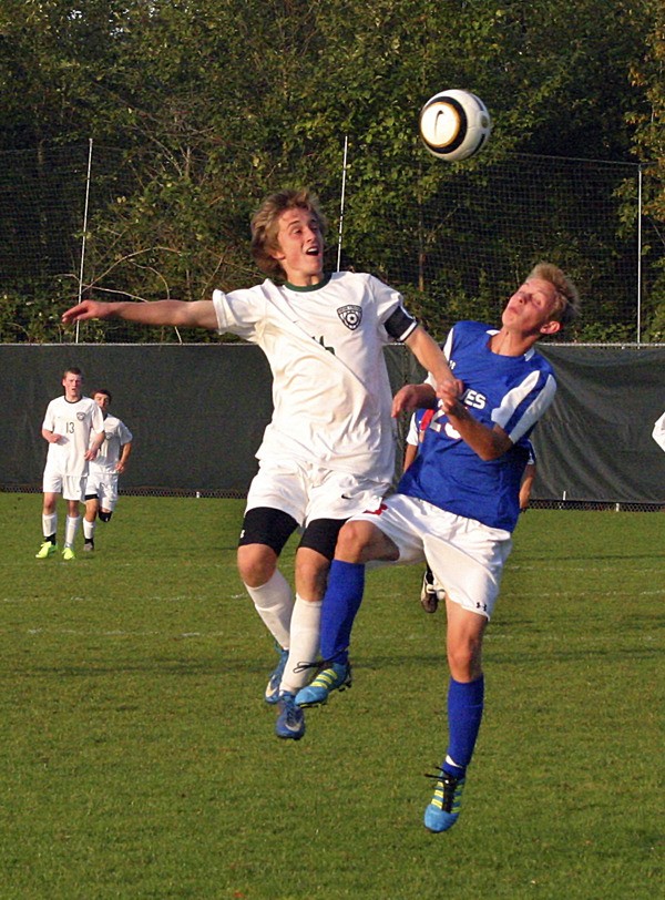 Bear Creek forward Mark Phillips (left) battles with La Conner midfielder Jack Borusinski for a header during Monday afternoon's nonleague matchup against the Braves. Phillips scored a goal in the Grizzlies' 2-0 shutout