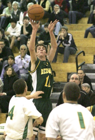 Redmond’s Chris Harrington fires up a shot during the Mustangs’ 42-41 Kingco playoff win at Roosevelt Tuesday night. Harrington hit two free throws with 18.2 seconds left that proved to be the difference in the game.