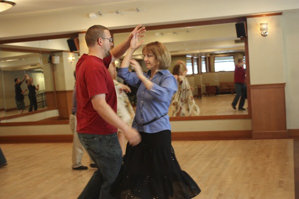 Aaron Peterson (left) and Peggy Hail practice the foxtrot during an afternoon class on Tuesday at DanceWorks Studio in downtown Redmond. The studio turns 11 this month.