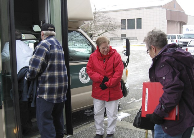 Driver Janice Dunlap (middle) waits as seniors board the bus at the Redmond Senior Center (RSC) for last Wednesday's trip to Tulalip Casino in Marysville. RSC officials originally planned to cancel the trip due to the snowy and icy road conditions