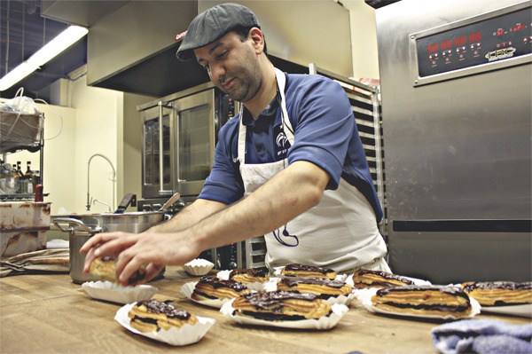 Khalid Kaskou prepares chocolate eclairs in the kitchen of Le Rendez-Vous