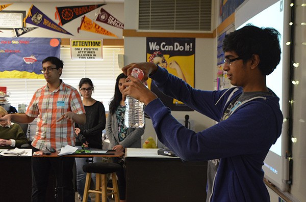 STEM High School junior Dinesh Parimi performs a demonstration in front of students at Inglewood Middle School in Sammamish.