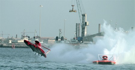 The U-5 Formulaboats.com Unlimited Hydroplane (left) gets airborne after catching the tail of the U-16 Ellstrom Elam Plus (right) during the finals of the Oryx World Cup in Doha