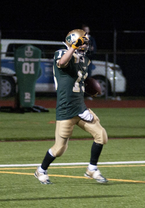Redmond High receiver Cody Klepinger celebrates in the end zone after running out a 67-yard touchdown pass from quarterback Michael Conforto in the fourth quarter to put the Mustangs up 16-0 last Friday night in their 20-6 victory over the Woodinville Falcons.