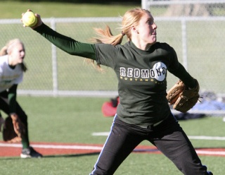 Erika Hendron pitches during a recent softball practice at Hartman Park. Hendron led the team to place third at state last spring after posting an 8-3 record and 1.92 ERA in the postseason.