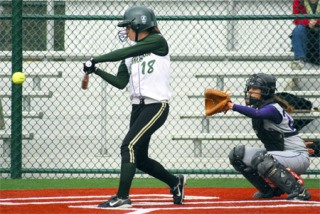 Redmond sophomore Sam Sunderland takes a swing at the ball during the Mustangs' 10-0 win against Garfield Friday afternoon. The game was played at the at the new field at Grass Lawn Park.