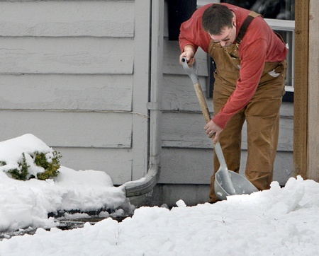 Jeff Chandler shovels snow from the walkway at a business near Northeast 80th Street and 166th Avenue Northeast during last December's snow storm. Following that storm