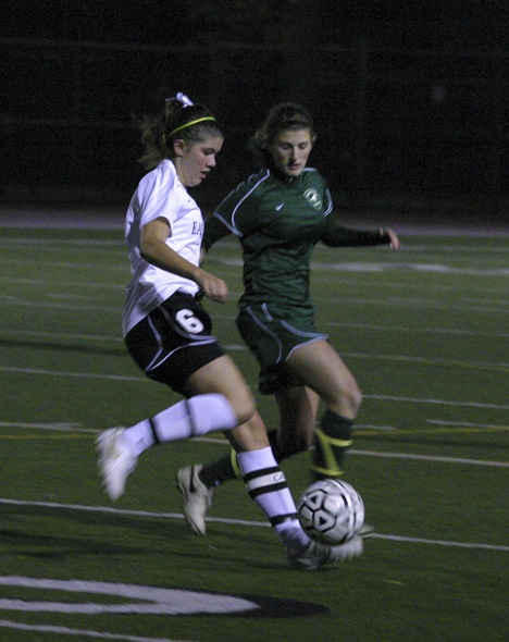 Redmond senior midfielder Celina Williams (right) battles for the ball with Eastlake senior Allie Beahan during Tuesday night's 4A Kingco league regular-season finale against the Wolves. Eastlake won 4-0 to tie for second place in the league while the Mustangs finished fifth and will play Woodinville in the first round this Saturday.
