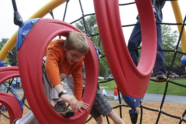 Jacob Meyers plays on the new playground equipment at Spiritbrook Neighborhood Park. The park officially reopened on Tuesday after seven months of renovations.