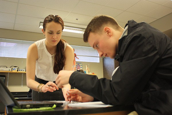 Sarah Herron (left) and Thomas Barnett work together on a lab during a recent class for Redmond High School’s STEM signature program. The program is focused on global health.