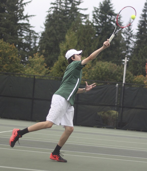 Redmond High’s Nikolay Bykov competes against Woodinville High at No. 1 singles on Tuesday.