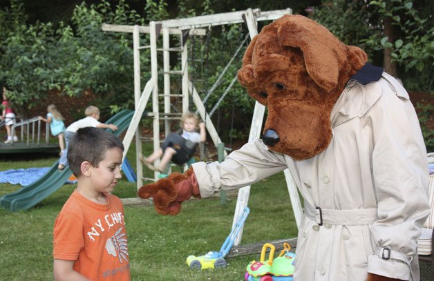 McGruff the Crime Dog interacts with Maxim Jackson during a National Night Out barbecue at Valley Estates in Redmond Tuesday night.