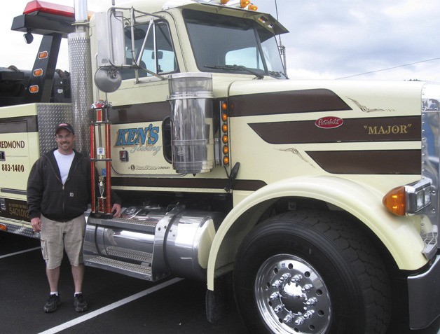 Ken's Towing truck driver Kyle Drew stands next to 'Major