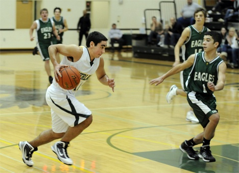 Senior guard Hakan Yagiz gets ready to drive past an Eagles' defender during the Owls' 71-41 win over Evergreen Lutheran on Tuesday night. One of three returning seniors