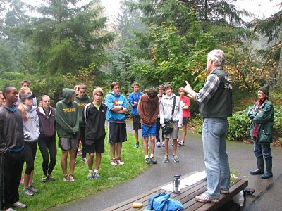 Green Redmond’s Mike Shaw and Roberta DeBruler discuss trail beautification with Redmond High cross country runners last Saturday at the Redmond Watershed Preserve.