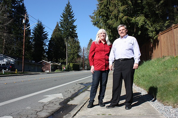 Education Hill residents Paula Parks (left) and Andy Galvins stand on a sidewalk along 166th Avenue Northeast