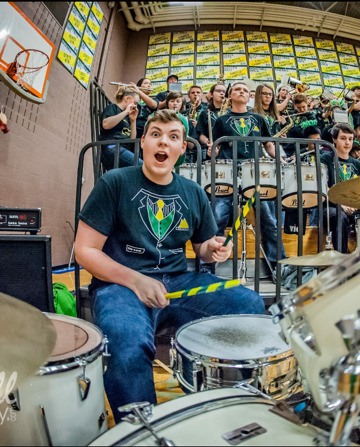 Redmond High's Nick Roels drums away at a Mustang basketball game.