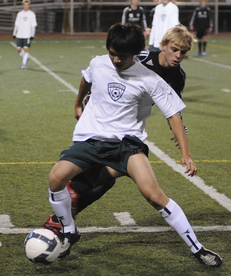 Bear Creek senior Nick Cho battles for the ball against a Mount Vernon Christian defender during the Grizzlies' state quarterfinals match against the Hurricanes. Cho scored one of his team's three second-half goals as the Grizzlies went on to win 4-1. They will play at 6 p.m. against La Conner on Friday at Sunset Chevrolet Stadium in Sumner in the semifinals.