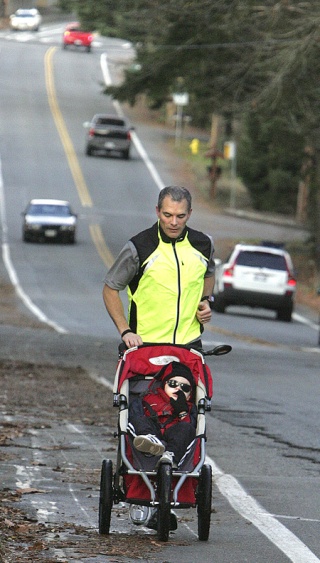 Don Graves pushes a stroller carrying his son