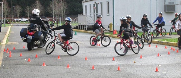 Redmond Middle School sixth-graders ride with a Redmond Police Department motorcycle officer.