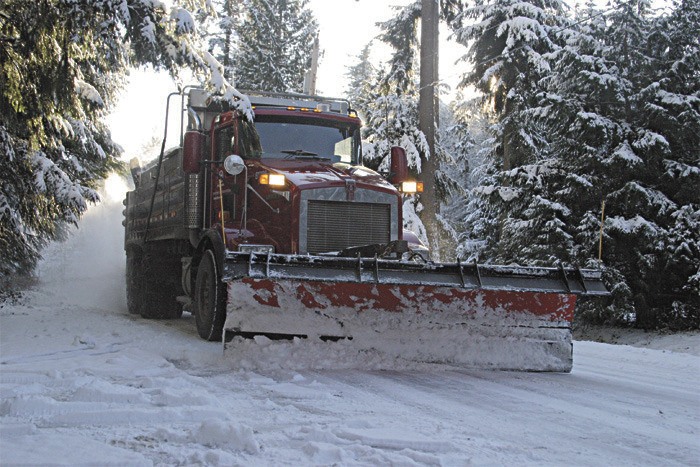 A King County snow plow clears snow off the road during a recent snow storm. Both the city and county have plows and sanders ready in the event of a snow storm.