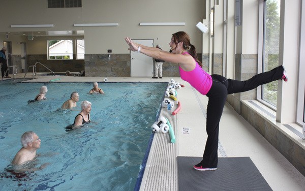 Kaela Berrien leads a water aerobics class in the new pool in the new fitness and wellness center at Emerald Heights Retirement Community in Redmond.