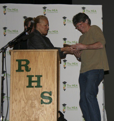 Redmond High School environmental science teacher Mike Town accepts the inaugural Green Prize for Public Education award from Harriet Sanford