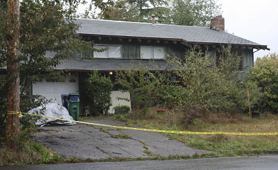 Police tape is strung in front of the house on the 14100 block of Northeast 72nd Street in Redmond where a 37-year-old man and his 4-year-old son were found and taken to area hospitals Tuesday afternoon for a suspected drug overdose.