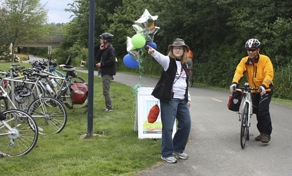 Lorraine Josifek points the way for Redmond resident Bill Tsang to this evening's City of Redmond Bike Bash along the Sammamish River Trail near City Hall. Josifek is on the city's Bicycle and Pedestrian Advisory Committee.