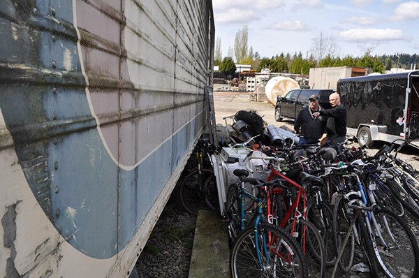 Eastside Baby Corner (EBC) volunteers Greg Wineland and Tim Sullivan select bikes from those collected by the Redmond Rotary that EBC will give to the local kids they serve.
