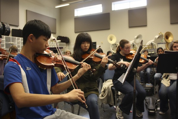 Redmond High School symphony students rehearse a piece Tuesday afternoon. The students will perform in a benefit concert tonight with the Microsoft Orchestra to raise money for their upcoming trip to Carnegie Hall in New York this March.