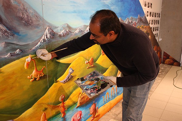 Vikram Madan works on an imaginary creature for his 'Imagination Northwest!' mural. The creatures in the mural are inspired by drawings from local kids.
