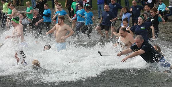 People brave the approximate 46-degree Lake Sammamish waters at Idylwood Park this morning for the Redmond Police Department Polar Plunge to benefit Special Olympics. An officer even risks getting his selfie stick wet during the plunge.  Story to come.