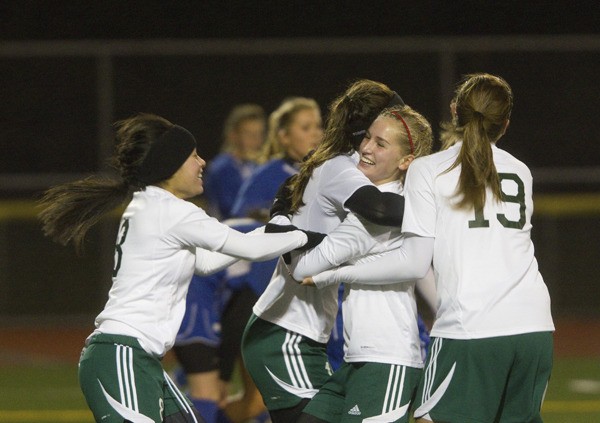 Teammates celebrate after Olivia Tillinghast (second from right) scores her first goal of the night in the Grizzlies' 6-2 semifinals win over Seattle Lutheran. The win advanced Bear Creek into the state semifinals this Friday night against Crosspoint Academy.