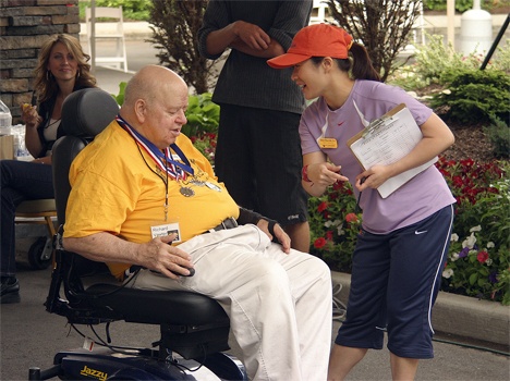 Fairwinds-Brighton Court resident Richard Vawter gets a debriefing on the rules of the Electric Cart Race by Fairwinds-Redmond PrimeFit instructor Rachel Lu.