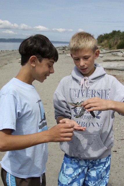 Sasha and Kolya examine a starfish they found on Richmond Beach in Shoreline. The two boys are part of a three-week program that pairs orphans from Ukraine with families in the greater Puget Sound area. The program is organized by Redmond native Karen Springs (not pictured)