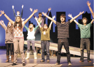 The cast performs during a rehearsal for the Redmond High School production of “Urinetown