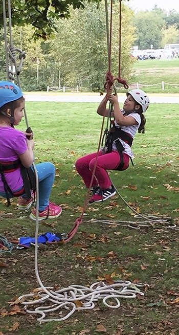 Troop 43814 members Zoe Litovkin (left) and Lauren Jernigan learn how to climb a tree at Marymoor Park in October.