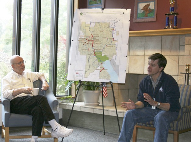 Redmond Senior Center advisory committee member Ray Anspach (left) listens as City of Redmond natural resources manager Jon Spangler describes how the city protects local streams and wildlife during the senior center's First Friday Coffee Chat on June 4.