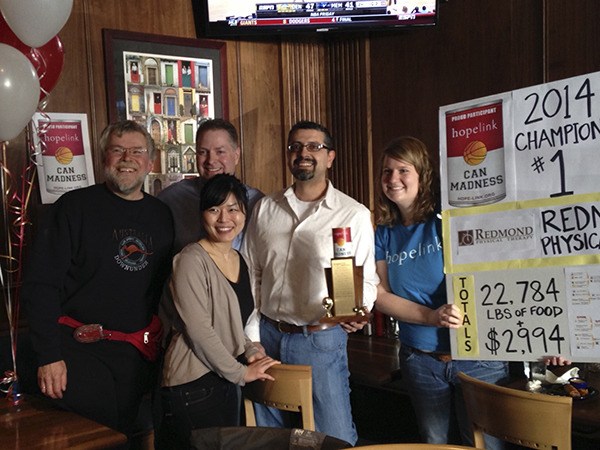 Redmond Physical Therapy accepting the Hopelink Can Madness trophy at JJ Mahoney’s on April 4. Left to right: Robert Hime