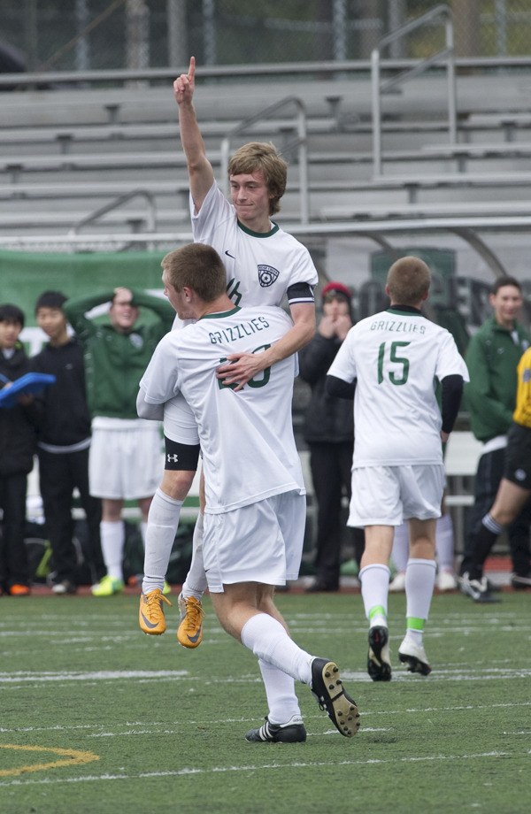 Bear Creek senior Mark Phillips gets lifted up by teammate Lucas Fernandez after scoring his first of two goals in the Grizzlies' consolation final game against St. George's. The Grizzlies gave up three late goals to lose