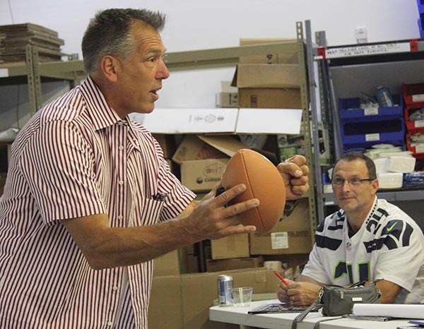 Former Seattle Seahawk quarterback and NFL coach Jim Zorn stresses a point during his 'Football 101' chalk talk on Thursday at Medical Teams International in Redmond.