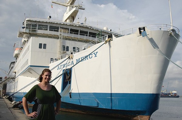 Former Redmond resident Kristin Jack stands next to the Africa Mercy ship.