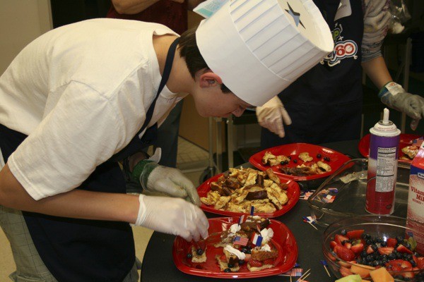 Redmond Junior High student Tyler Nielson prepares French Toast with Fruit samples for judges at the 'So You Think You Can Cook?' contest Wednesday afternoon. The contest was linked to a year-long