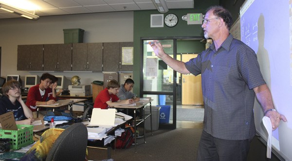 Redmond High School math teacher Sandy Hargraves answers students' questions during a review session for an upcoming pre-calculus final exam. Hargraves has been at the school for 30 years and will retire at the end of the year.