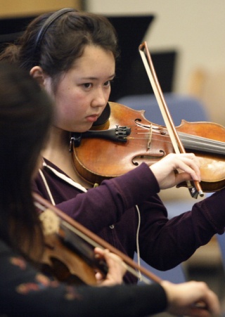 Redmond High School sophomore Mana Maloney plays with the orchestra during a rehearsal at Redmond High School last Friday. The orchestra students will perform at New York’s prestigious Carnegie Hall on Sunday
