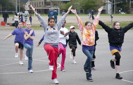 Members of the Eastside Precision Drill Team practice on the playground at Redmond Elementary School for this weekend's Seattle All City Drill Team competition in Edmonds. The team is recruiting more girls from grades K-12. For information